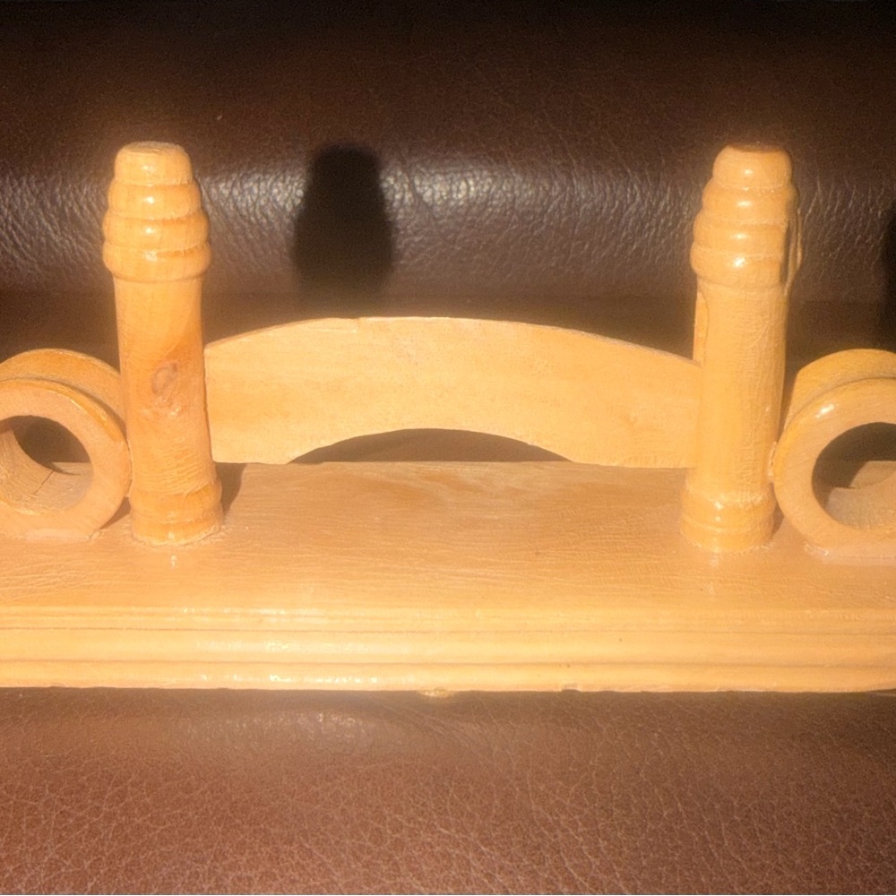 This is a natural wood hand fan display stand.